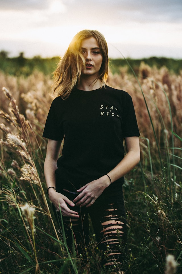 Woman in black T-Shirt standing in forest