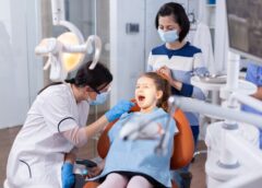 pediatric dentist examining a child's teeth in a dental clinic