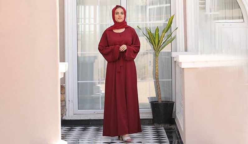 woman is wearing cherry maroon dress